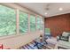 Comfortable sunroom with brick accent wall and tranquil view of greenery at 4355 Old Hamilton Mill Rd, Buford, GA 30518