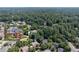 Aerial view of a neighborhood featuring a beautiful home with lush landscaping at 4567 Brigade Ne Ct, Roswell, GA 30075