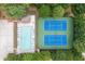 Aerial view of community amenities including a pool, tennis courts, parking and lots of surrounding trees at 4567 Brigade Ne Ct, Roswell, GA 30075