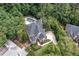 Aerial view of a lovely home with a pool, mature trees, and well-maintained landscaping at 4567 Brigade Ne Ct, Roswell, GA 30075