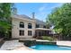 A backyard featuring a swimming pool, hot tub, and a spacious deck, perfect for outdoor relaxation and entertainment at 4567 Brigade Ne Ct, Roswell, GA 30075