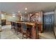 Basement bar area featuring a hardwood bar, barstool seating, cabinetry, and flooring at 4567 Brigade Ne Ct, Roswell, GA 30075