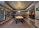Finished basement featuring a pool table, tile flooring, bar area, and rustic decor at 4567 Brigade Ne Ct, Roswell, GA 30075