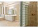 Spa-like bathroom with a glass block shower, double vanity, and elegant tile work for a luxurious retreat at 4567 Brigade Ne Ct, Roswell, GA 30075