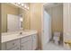 An off-white bathroom with a vanity and a white-tiled shower/toilet area at 4567 Brigade Ne Ct, Roswell, GA 30075