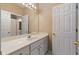 Bathroom with white vanity, large mirror, and lots of natural light at 4567 Brigade Ne Ct, Roswell, GA 30075