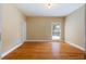 Bedroom with hardwood floors, white trim, and a window with a view of a basketball hoop at 4567 Brigade Ne Ct, Roswell, GA 30075