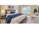 Bedroom featuring neutral walls, a bed, and a large window at 4567 Brigade Ne Ct, Roswell, GA 30075