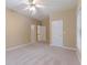Spacious bedroom with neutral walls, white doors, carpet and a ceiling fan at 4567 Brigade Ne Ct, Roswell, GA 30075