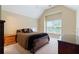 Bedroom with vaulted ceiling, neutral walls, plush carpet, and a window for natural light at 4567 Brigade Ne Ct, Roswell, GA 30075