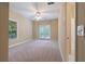 Bright bedroom with a ceiling fan and french doors leading to a balcony at 4567 Brigade Ne Ct, Roswell, GA 30075