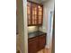 Butlers pantry with dark granite countertop and lighted glass front cabinets at 4567 Brigade Ne Ct, Roswell, GA 30075