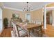Charming dining room featuring a rustic wooden table, striped chairs, hardwood floors, and ample natural light at 4567 Brigade Ne Ct, Roswell, GA 30075
