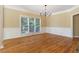 Formal dining room featuring hardwood floors, wainscoting, and a large window at 4567 Brigade Ne Ct, Roswell, GA 30075