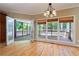 Dining room with wood floors, decorative lighting, and a view of the screened in porch at 4567 Brigade Ne Ct, Roswell, GA 30075