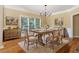 Cozy dining room featuring a wooden table, neutral decor, and hardwood floors at 4567 Brigade Ne Ct, Roswell, GA 30075