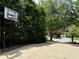 Home's driveway featuring a basketball hoop and lots of surrounding greenery at 4567 Brigade Ne Ct, Roswell, GA 30075