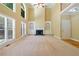Spacious living room with a fireplace, two-story ceilings, and neutral decor. Waiting for your personal touch at 4567 Brigade Ne Ct, Roswell, GA 30075