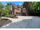 A brick two-story home featuring a two-car garage and a basketball hoop. It has a manicured lawn and paved driveway at 4567 Brigade Ne Ct, Roswell, GA 30075