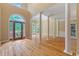 Spacious foyer featuring hardwood floors, large columns and a decorative entry door at 4567 Brigade Ne Ct, Roswell, GA 30075