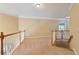 Upstairs hallway featuring neutral carpet and paint, plus a view of downstairs at 4567 Brigade Ne Ct, Roswell, GA 30075