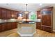 Gourmet kitchen with a center island, granite countertops, custom wood cabinets, and stainless steel appliances at 4567 Brigade Ne Ct, Roswell, GA 30075