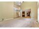 A large living room featuring carpet, tall ceilings and a view of a staircase and partial kitchen at 4567 Brigade Ne Ct, Roswell, GA 30075