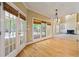 Open living area with hardwood floors, fireplace, and doors to the screened porch at 4567 Brigade Ne Ct, Roswell, GA 30075