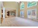 Spacious living room with tall windows providing natural light and access to an outdoor balcony at 4567 Brigade Ne Ct, Roswell, GA 30075