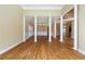 Open-concept living space featuring hardwood floors, white columns, and natural light at 4567 Brigade Ne Ct, Roswell, GA 30075