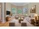 Comfortable living room featuring a bay window, wooden floors, and neutral tones perfect for relaxation at 4567 Brigade Ne Ct, Roswell, GA 30075