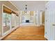 Open concept living room with hardwood floors, large windows, and a fireplace at 4567 Brigade Ne Ct, Roswell, GA 30075