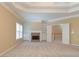 Carpeted primary bedroom with a fireplace, built-in shelves, and ample natural light at 4567 Brigade Ne Ct, Roswell, GA 30075