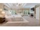 Serene main bedroom boasts a fireplace, plush carpet, tray ceiling, and a luxurious, all-white aesthetic at 4567 Brigade Ne Ct, Roswell, GA 30075