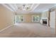 Spacious main bedroom with a fireplace, trey ceiling, carpet, and natural light at 4567 Brigade Ne Ct, Roswell, GA 30075