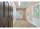 A mud room featuring a tile floor, closet, multiple doors, and a window providing ample lighting at 4567 Brigade Ne Ct, Roswell, GA 30075