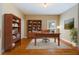 Cozy home office with built-in bookcases, hardwood floors, and a large window at 4567 Brigade Ne Ct, Roswell, GA 30075