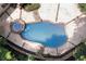 Aerial view of backyard pool and spa surrounded by stone patio and mature trees at 4567 Brigade Ne Ct, Roswell, GA 30075