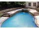 Beautiful in-ground pool and spa, stone waterfall, landscaping, and fenced yard at 4567 Brigade Ne Ct, Roswell, GA 30075