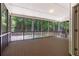 Inviting screened-in porch with wood flooring overlooking a refreshing pool and lush greenery at 4567 Brigade Ne Ct, Roswell, GA 30075