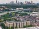 Stunning aerial view of multi-story condo with the vibrant cityscape of Atlanta in the background at 711 Cosmopolitan Ne Dr # 300, Atlanta, GA 30324