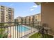 Relaxing balcony view of a community pool surrounded by lush landscaping and nearby building at 711 Cosmopolitan Ne Dr # 300, Atlanta, GA 30324