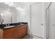 Bathroom featuring a double vanity with dark countertops and a glass enclosed shower at 711 Cosmopolitan Ne Dr # 300, Atlanta, GA 30324