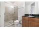Well-maintained bathroom with a glass-door shower, toilet, and vanity with stone counter at 711 Cosmopolitan Ne Dr # 300, Atlanta, GA 30324