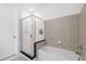 Modern bathroom featuring a shower with glass door and tiled walls at 711 Cosmopolitan Ne Dr # 300, Atlanta, GA 30324