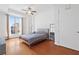 A cozy bedroom with hardwood floors, natural light, ceiling fan and a minimalist design at 711 Cosmopolitan Ne Dr # 300, Atlanta, GA 30324