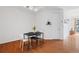 Dining area with modern black table and white chairs next to a window and door to outside at 711 Cosmopolitan Ne Dr # 300, Atlanta, GA 30324