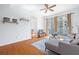 Bright living room featuring comfortable sofa, hardwood floors, and balcony access at 711 Cosmopolitan Ne Dr # 300, Atlanta, GA 30324