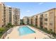 Stunning view of a large pool with many lounge chairs surrounded by buildings at 711 Cosmopolitan Ne Dr # 300, Atlanta, GA 30324
