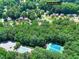 An aerial shot that shows the house is near a pool and tennis courts at 1935 Shrader Ct, Lawrenceville, GA 30044